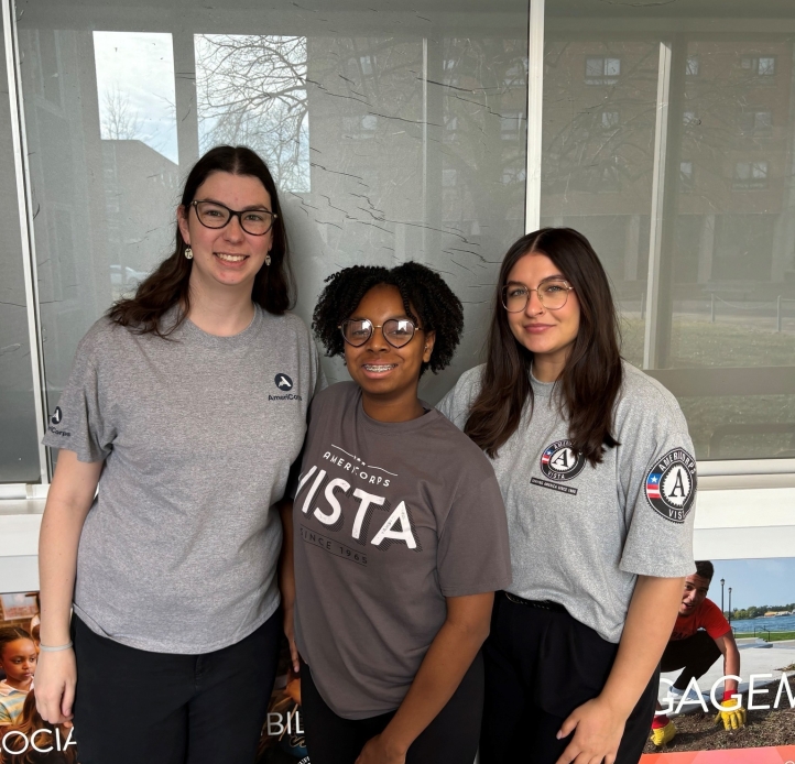 americorps members, three women standing in americorps t shirts.